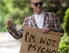 John Waters als Anhalter mit Schild: "I'm not psycho"