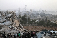 © AFP PHOTO / GEORGE OURFALIAN Syrian regime forces gather at the Kindi Hospital as smoke billows following aistrikes on Aleppo on October 2, 2016