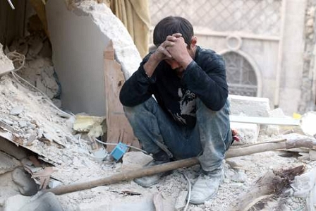 © AFP PHOTO / THAER MOHAMMED A Syrian man reacts as he sits on the rubble of destroyed buildings following a government forces air strike on the rebel- held neighbourhood of Bustan al- Basha in the northern city of Aleppo