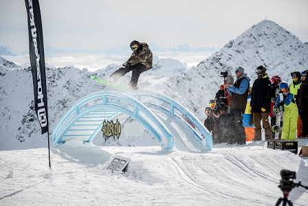 Snowboarder slidet über ein Rail