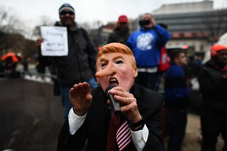 Demonstrators protest against US President-elect Donald Trump before his inauguration on January 20, 2017, in Washington, DC.